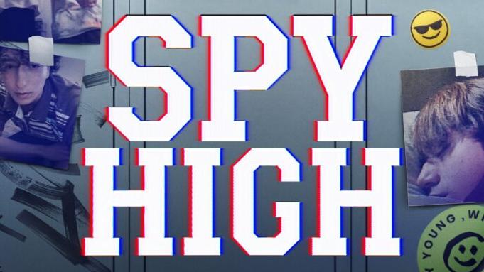 A school locker with a large camera lens in the center surrounded by photos and stickers, promoting the series "Spy High" on Prime.