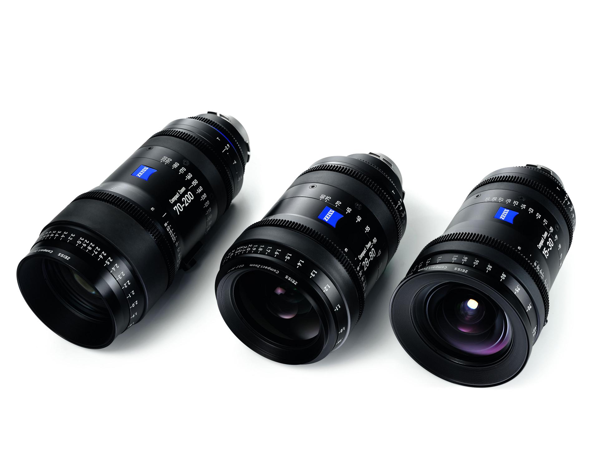 Three professional ZEISS camera lenses are arranged on a white background, showcasing their detailed markings and glass elements.
