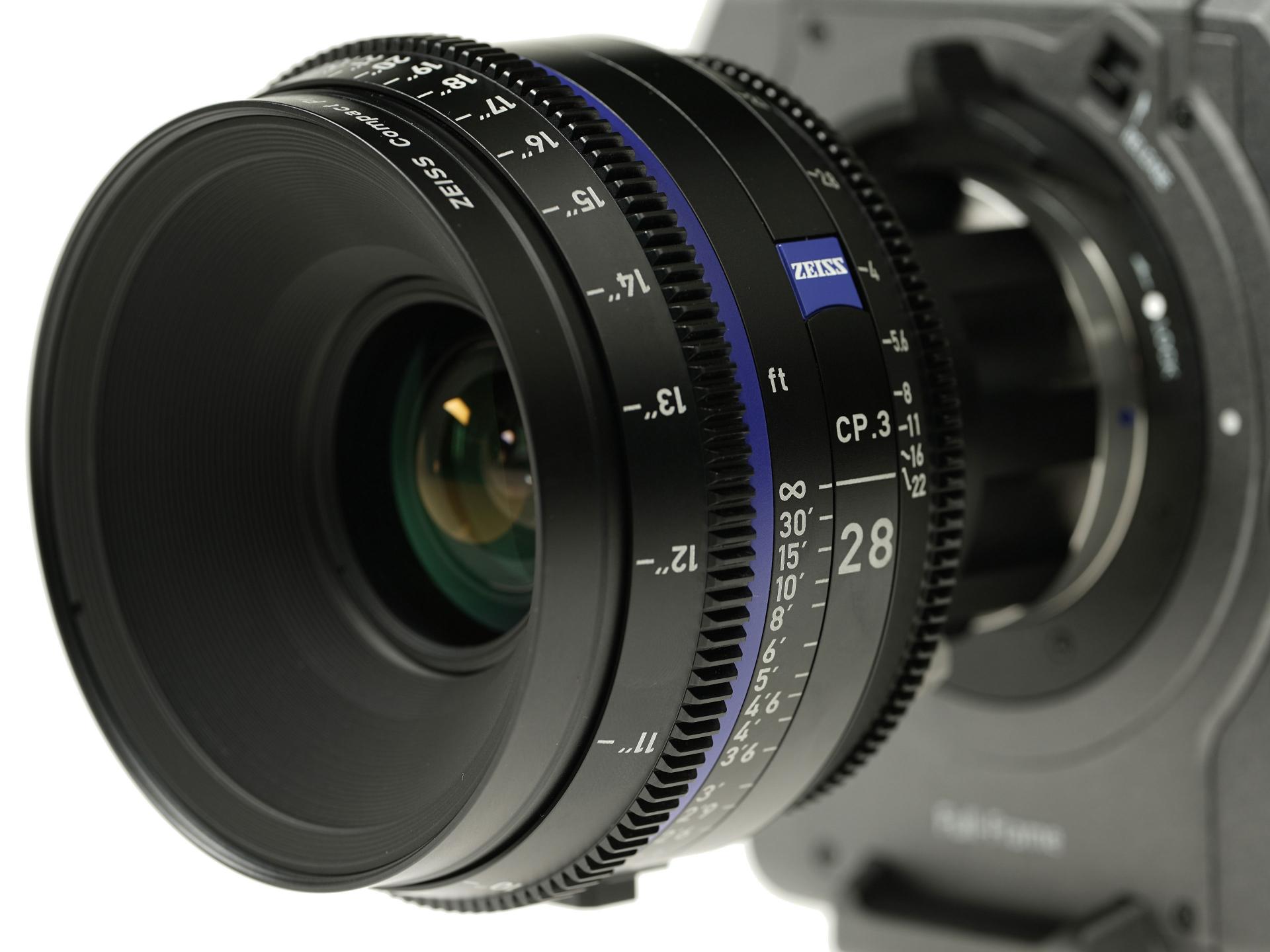 Close-up view of a ZEISS CP.3 28mm cinema lens mounted on a professional camera.