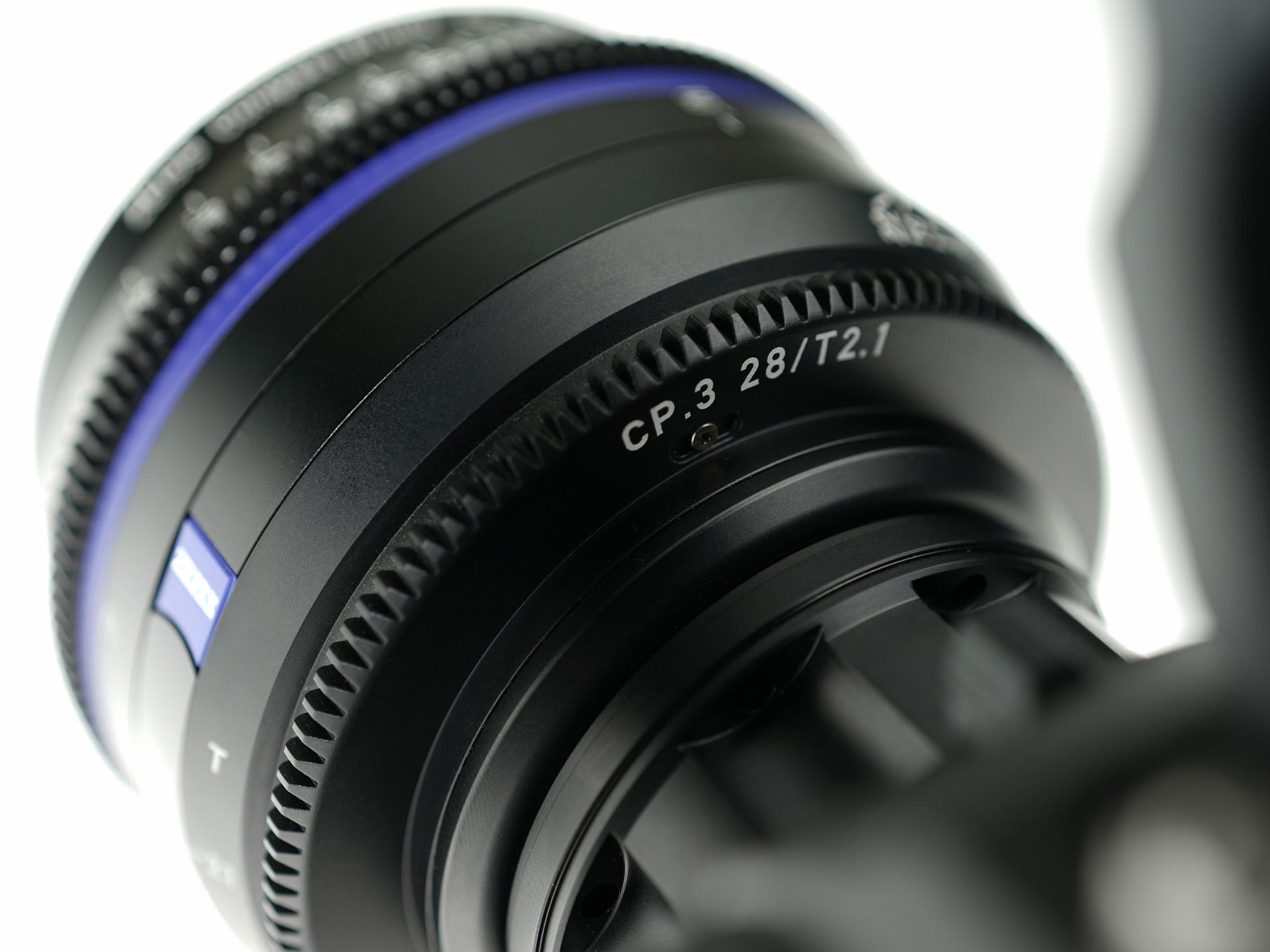 Close-up of a ZEISS CP.3 28/T2.1 cinema lens mounted on a camera.