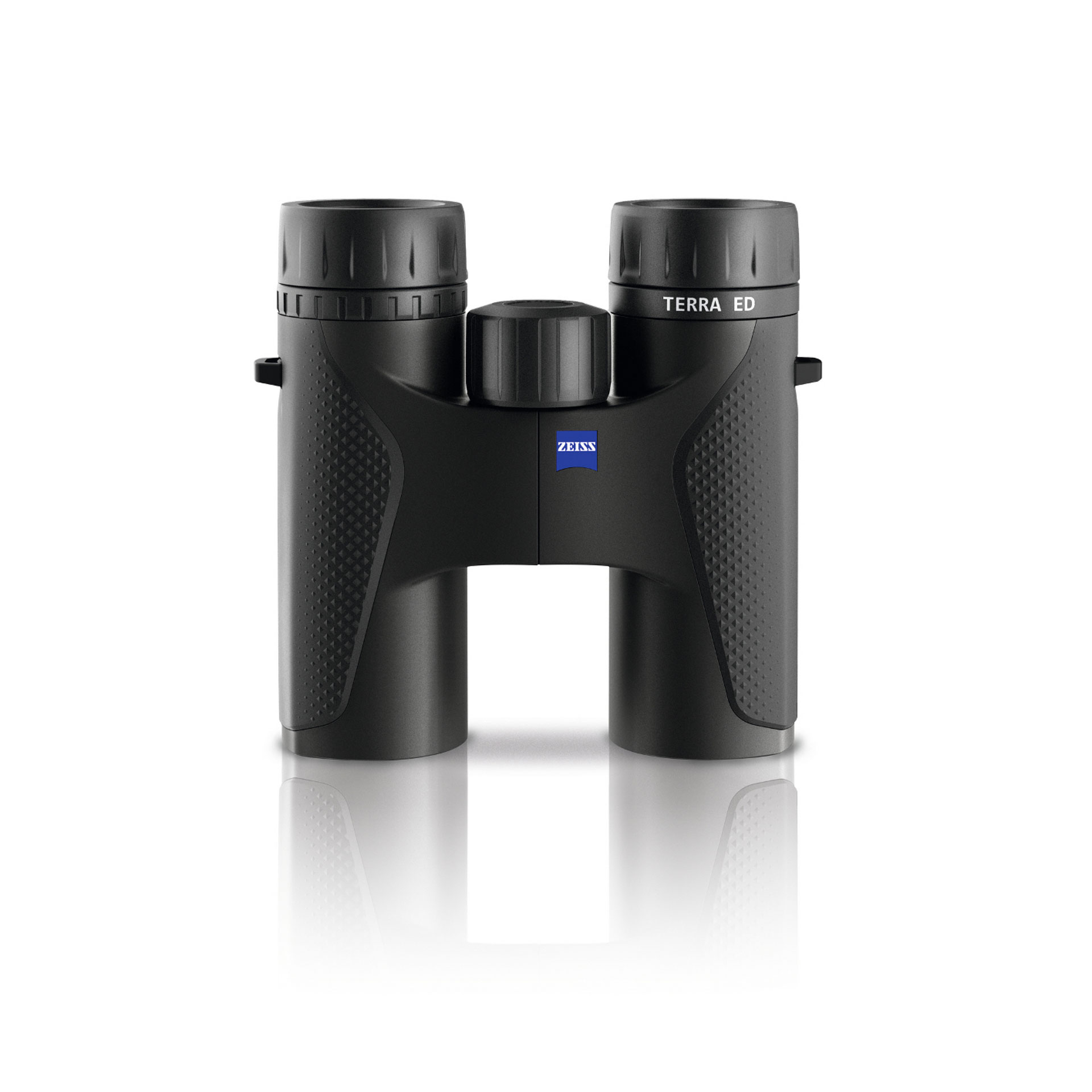 Black ZEISS TERRA ED binoculars with textured grips and central focus wheel, displayed upright on a white reflective surface.