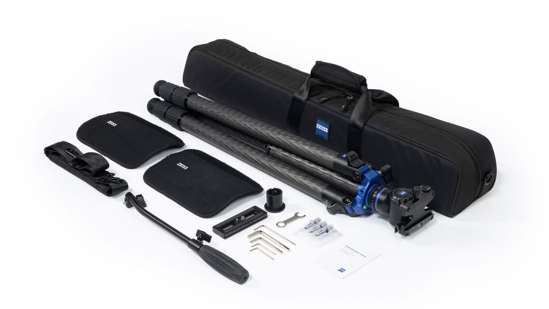 ZEISS professional tripod set with carbon tripod, carrying case, mounting accessories, and tools laid out for use.