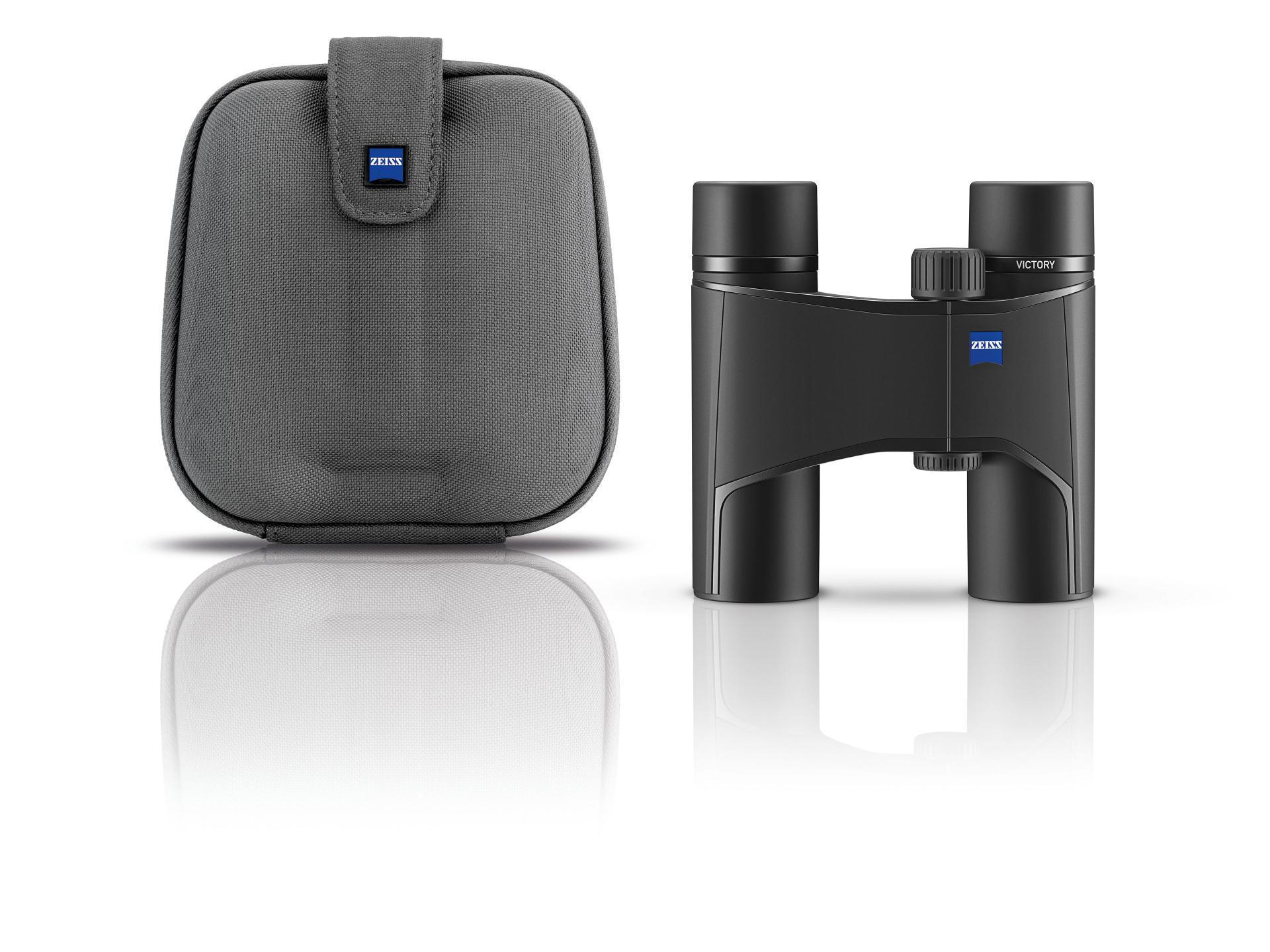 Compact black ZEISS binoculars displayed next to a matching gray carrying case, both featuring the ZEISS logo.