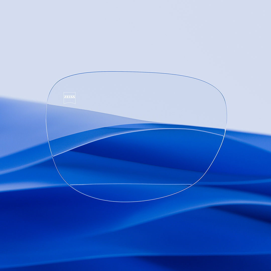 Image fractionnée d’un verre d’un côté transparent et propre, muni de ZEISS DuraVision, et de l’autre côté couvert de rayures.