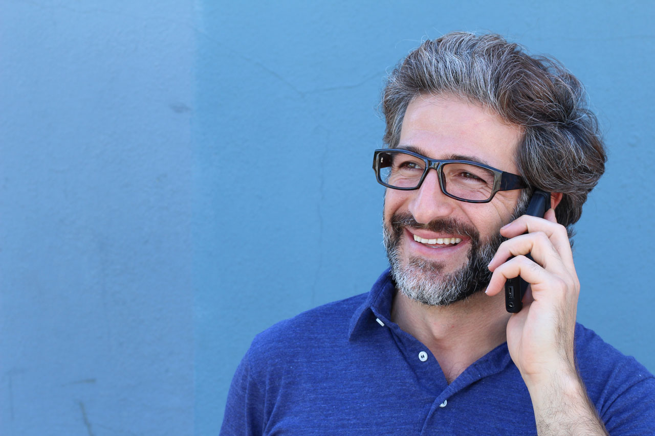 Un homme portant des lunettes et téléphonant au portable