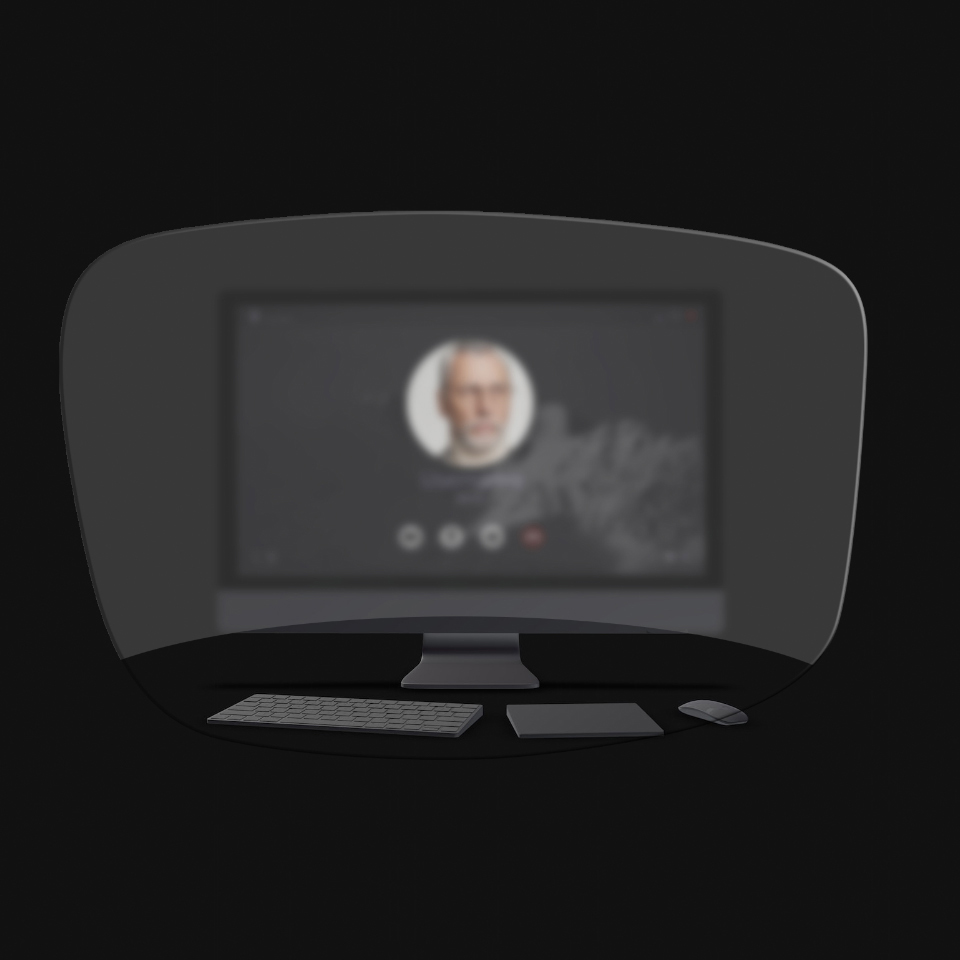 Vue d’un ordinateur de bureau, d’un clavier et d’une souris ainsi que d’un livre à travers une illustration schématique des lunettes de lecture pour montrer que seuls les objets très proches sont clairement visibles. L’écran d’ordinateur est flou.