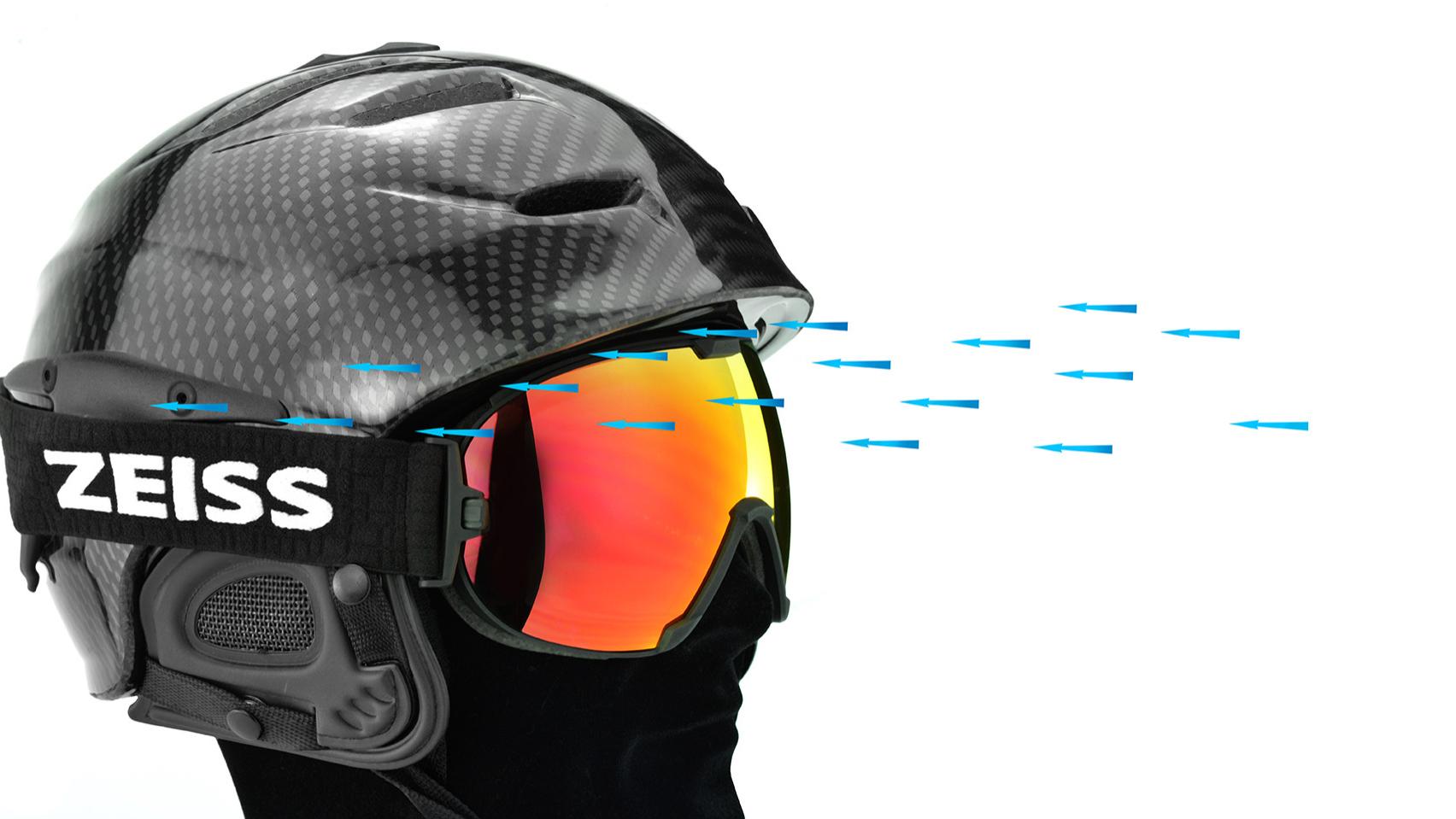 Casque noir et lunettes de ski ZEISS rouges.